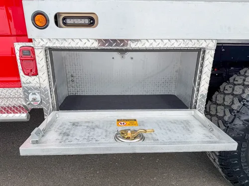 Open lower rear-side compartment with drop-down step platform.